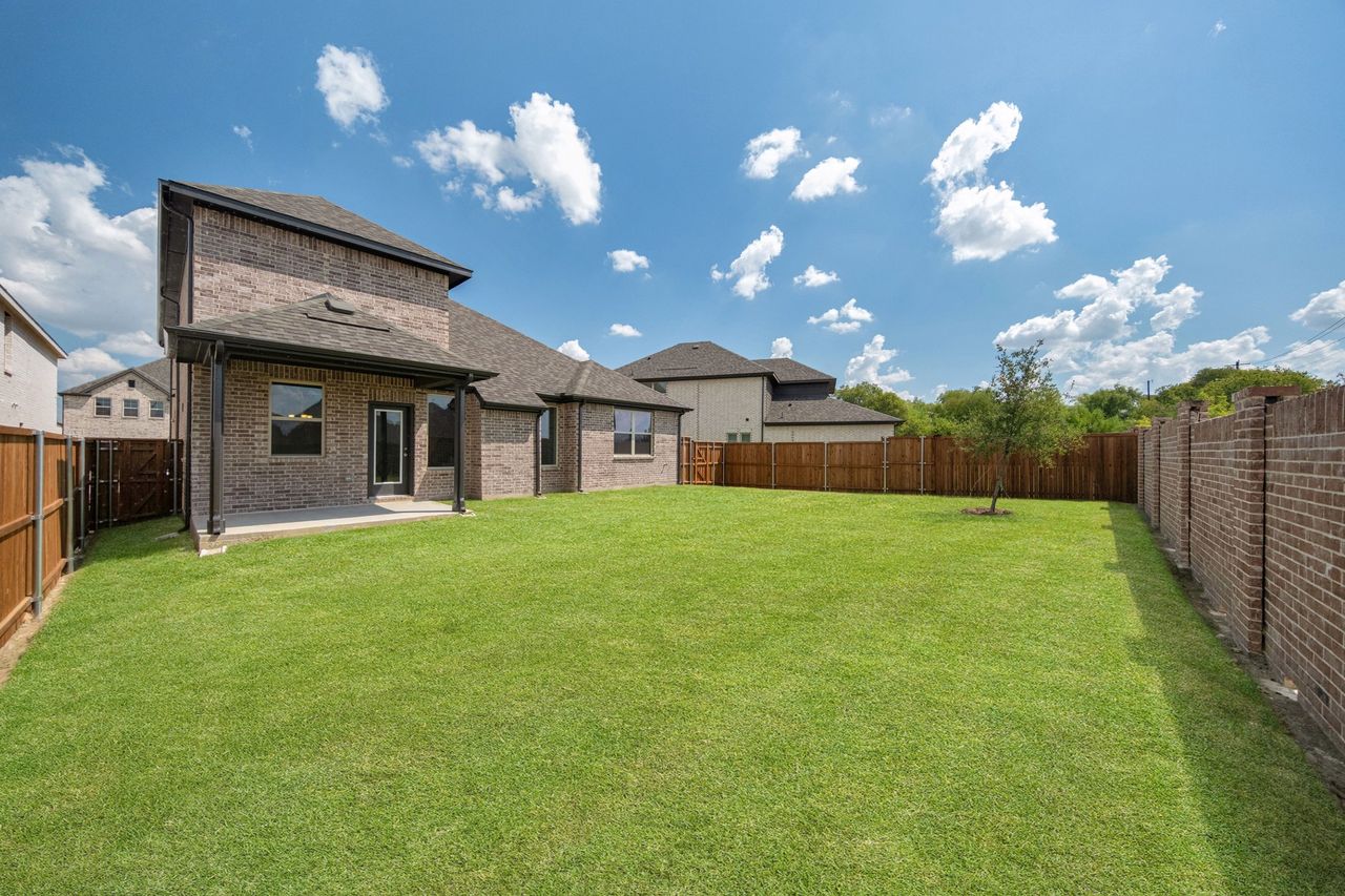 Exterior details and patio area of a home in Enclave at Legacy Hills: Crossings 50', Celina (Image 2).