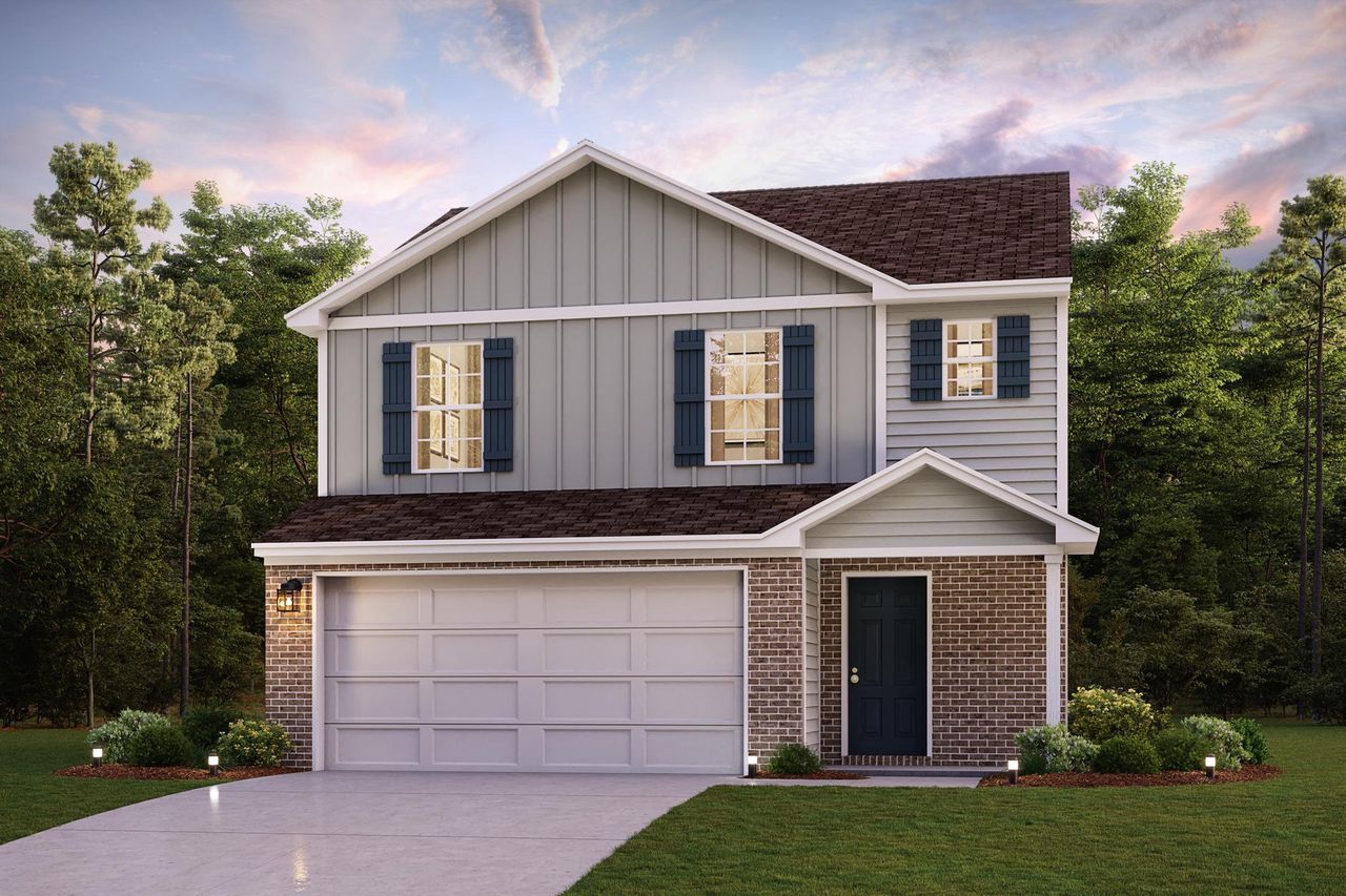 A house with a garage and trees in the back.