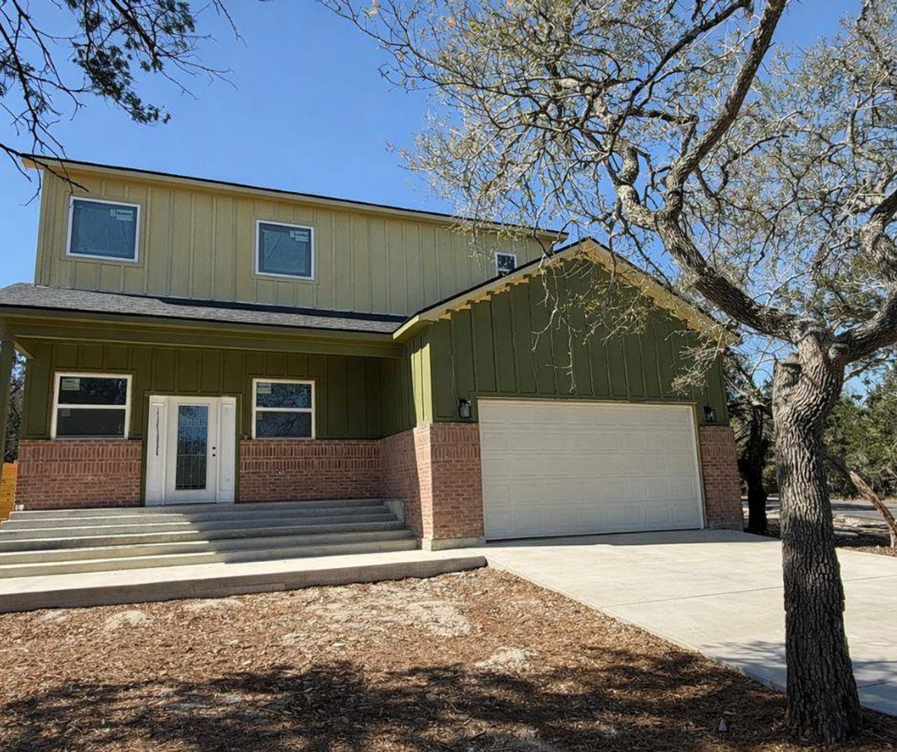 Front exterior of a new home in , Wimberley, TX, highlighting curb appeal (Image 2).