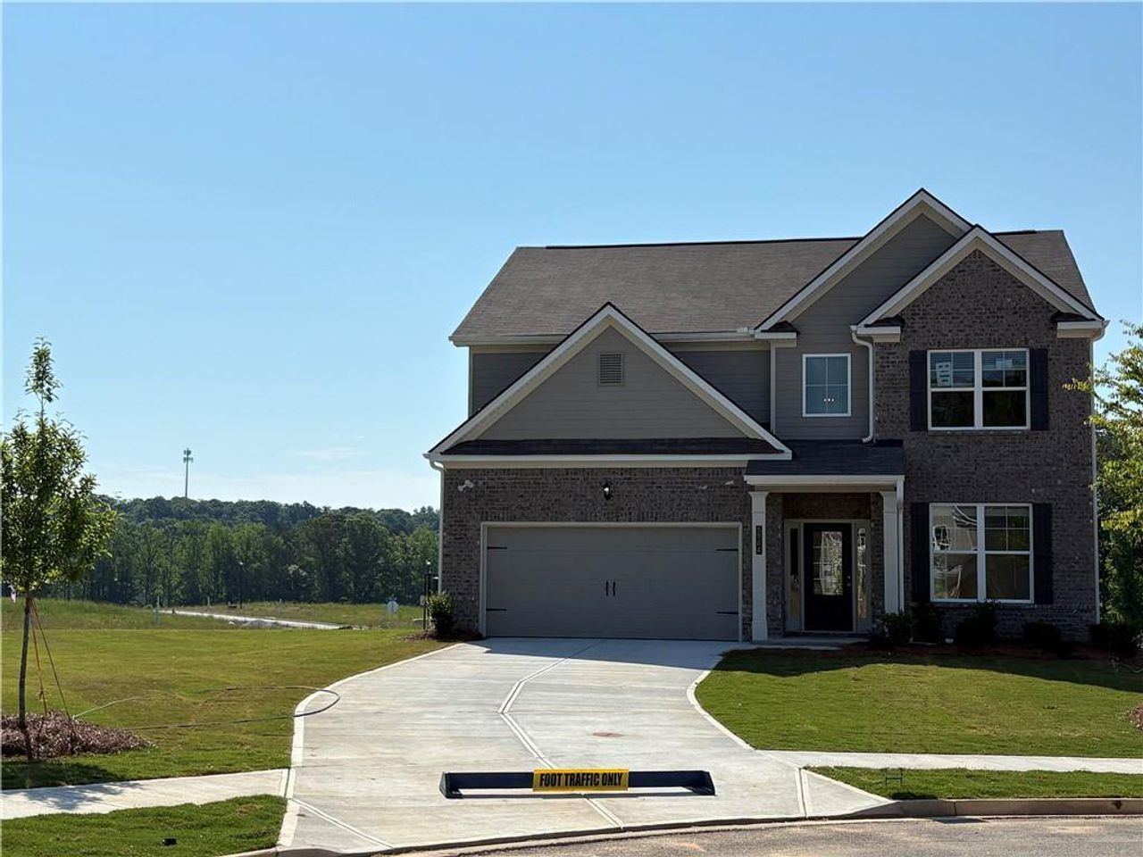 Front exterior of a new home in Highland Park, Stonecrest, GA, highlighting curb appeal (Image 2). Front exterior of a new home in Highland Park, Stonecrest, GA, highlighting curb appeal (Image 2).