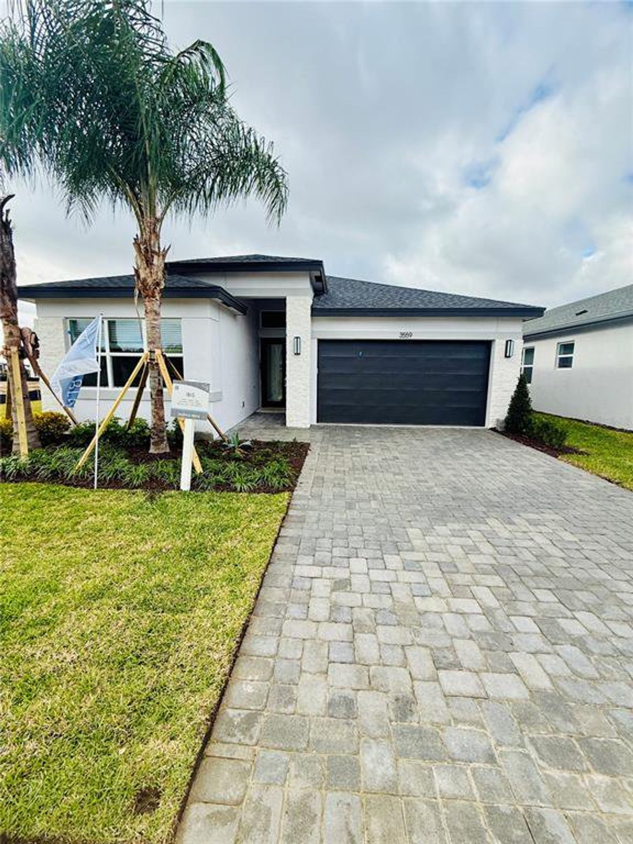 Front exterior of a new home in Valencia Ridge, Wesley Chapel, FL, highlighting curb appeal (Image 2).
