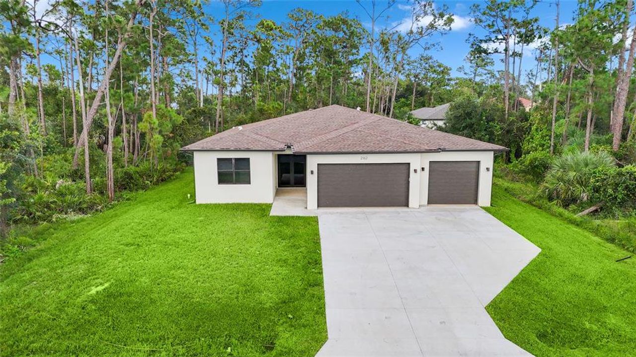 Front exterior of a new home in , Punta Gorda, FL, highlighting curb appeal (Image 2).
