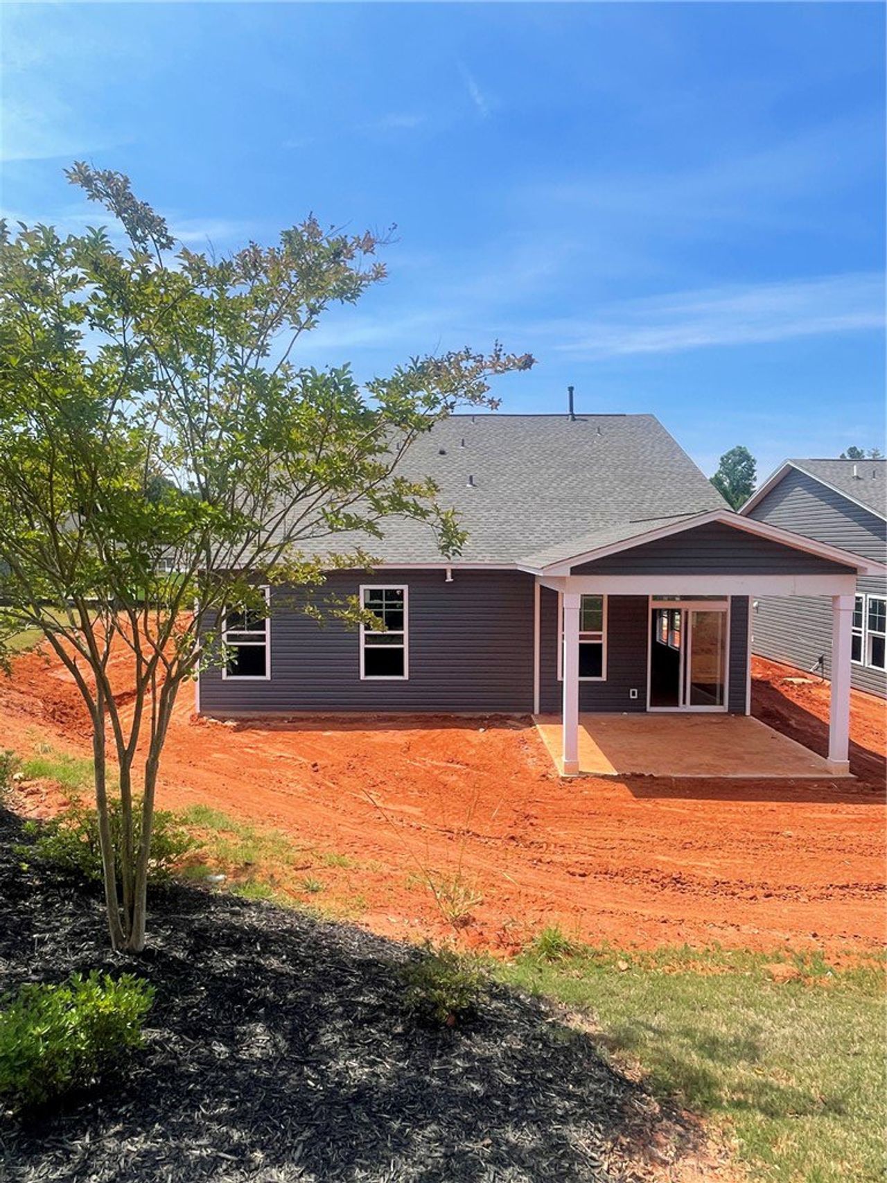 Exterior details and patio area of a home in Springwood Grove, Central (Image 2).