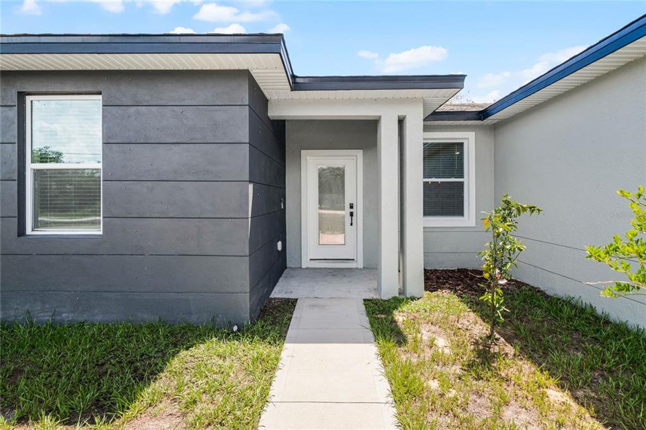 Front exterior of a new home in , Kissimmee, FL, highlighting curb appeal (Image 2). Front exterior of a new home in , Kissimmee, FL, highlighting curb appeal (Image 2).