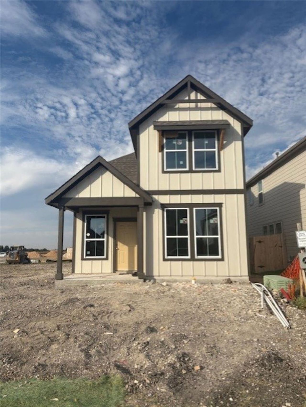 View of front of house with board and batten siding and a shingled roof View of front of house with board and batten siding and a shingled roof