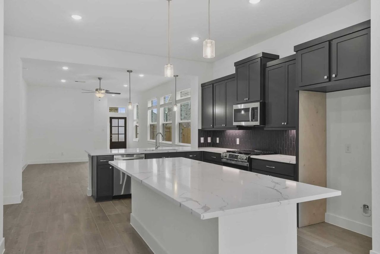 Representative furnished interior of a home built from the Carlisle by Chesmar Homes in Sunterra, Katy (Image 2).