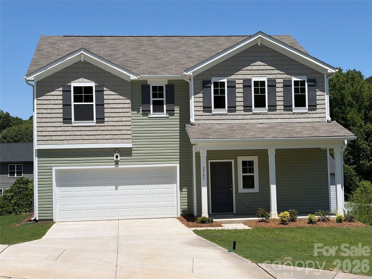Front exterior of a new home in Fisher Springs, Kannapolis, NC, highlighting curb appeal (Image 2).