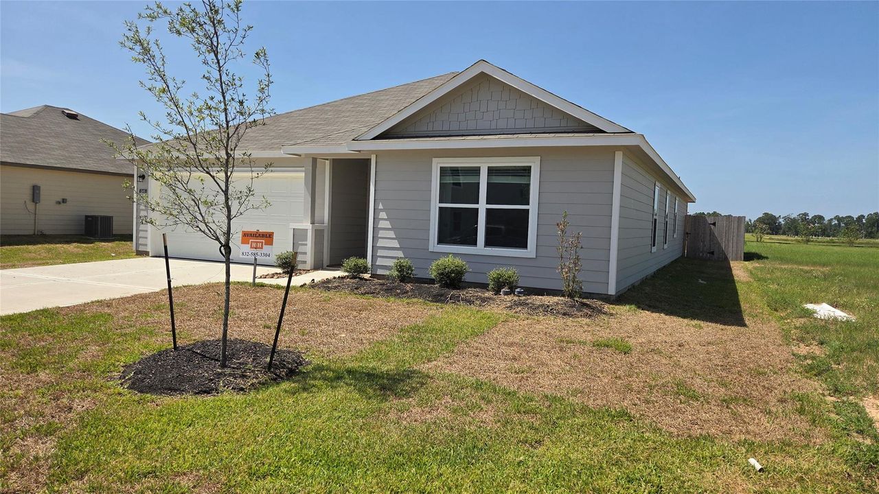Front exterior of a new home in , Conroe, TX, highlighting curb appeal (Image 2).