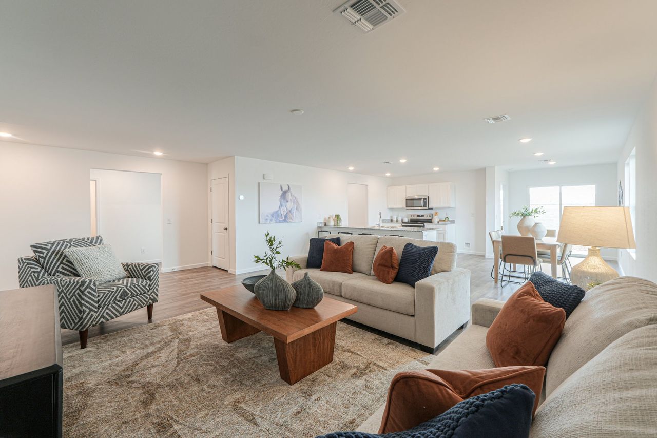 A living room with a couch and a coffee table. A living room with a couch and a coffee table.