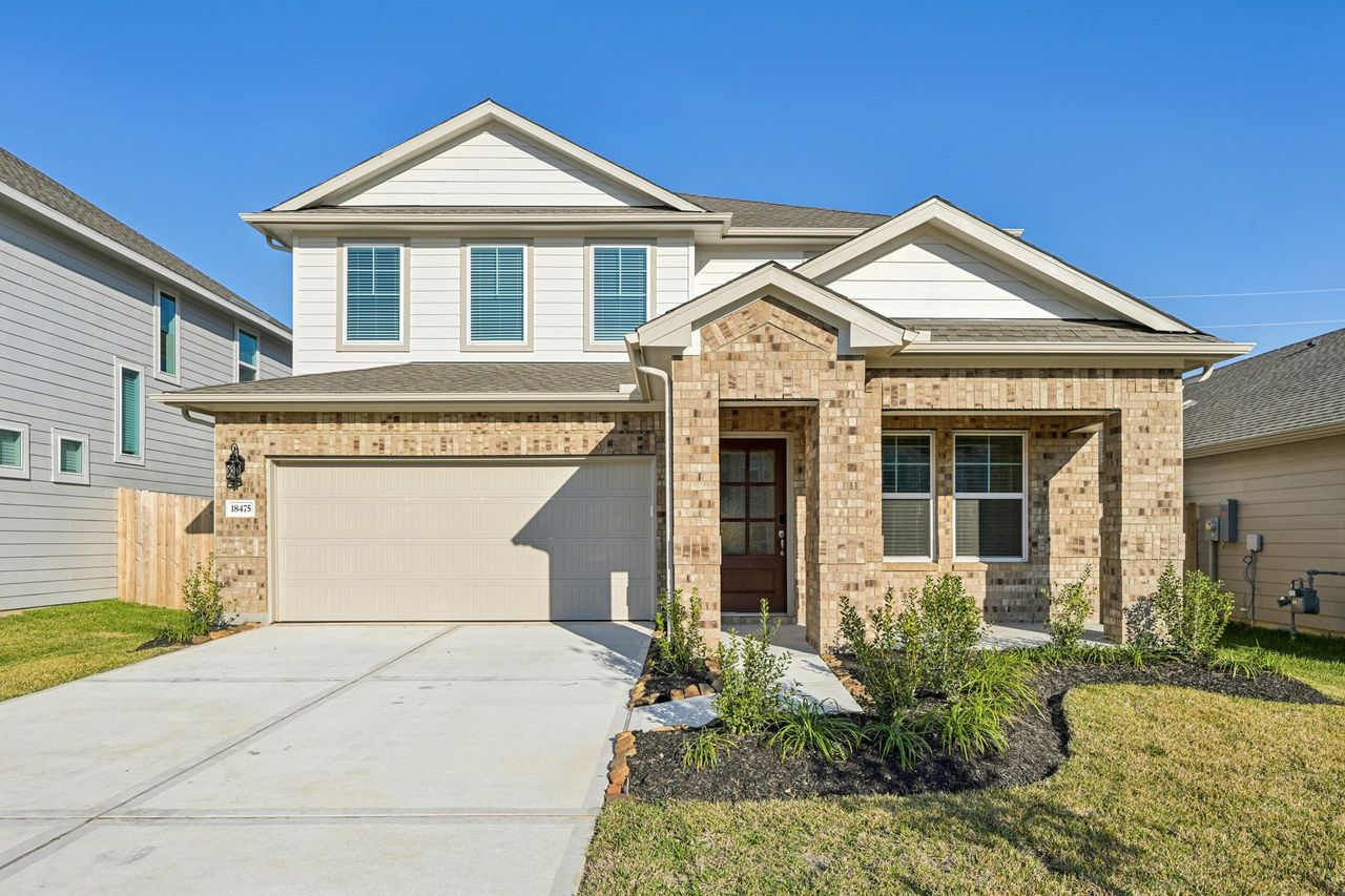 Front exterior of a new home in Landing Meadows - Premier Series, New Caney, TX, highlighting curb appeal (Image 2). Front exterior of a new home in Landing Meadows - Premier Series, New Caney, TX, highlighting curb appeal (Image 2).