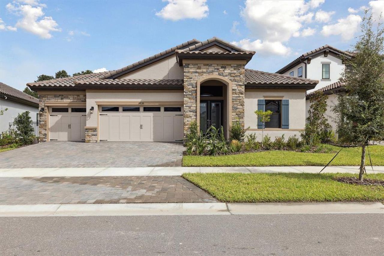 Front exterior of a new home in Hawkstone, Lithia, FL, highlighting curb appeal (Image 2).