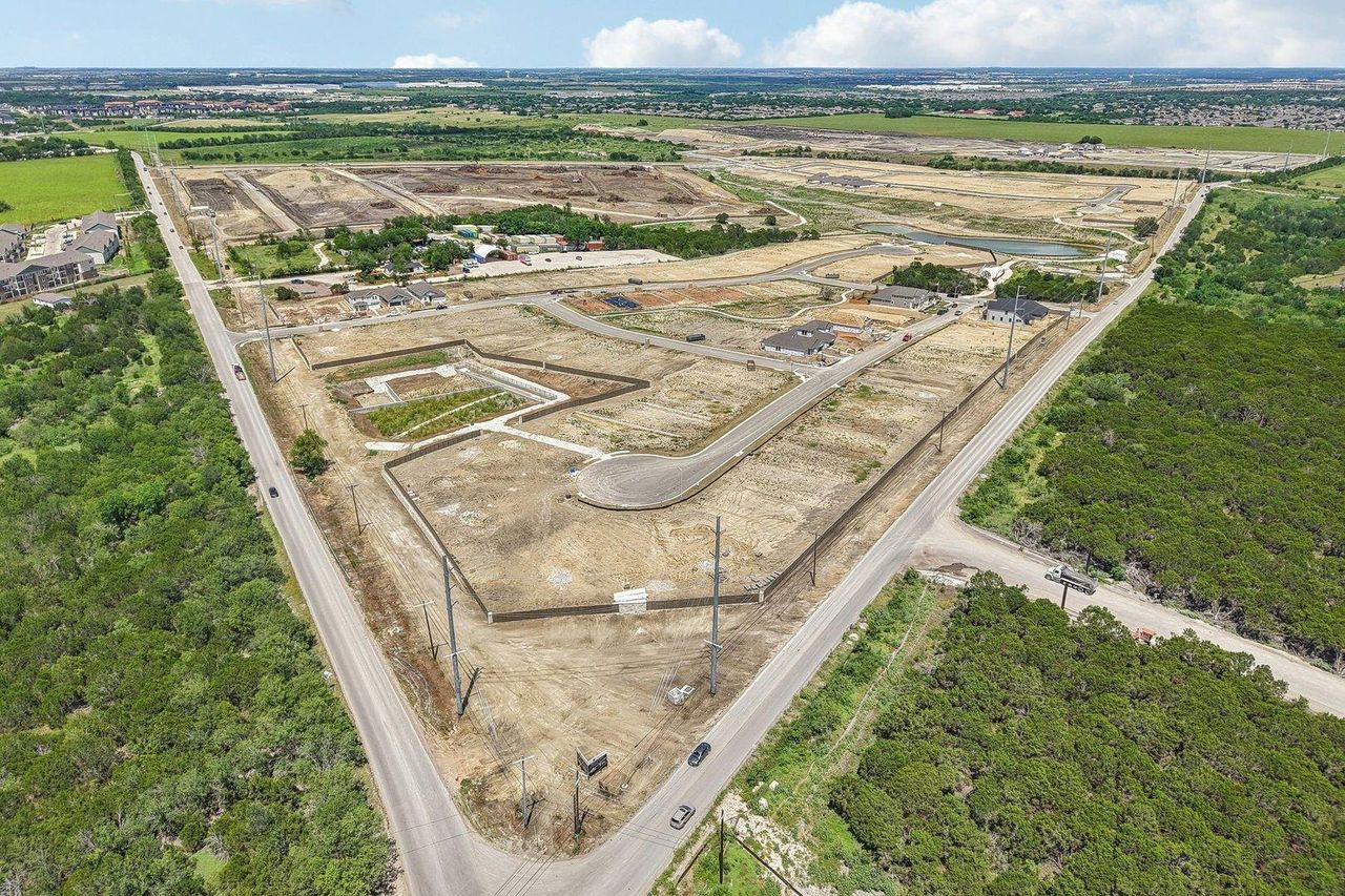 An aerial perspective shows paved roads and graded lots ready for residential development. An aerial perspective shows paved roads and graded lots ready for residential development.