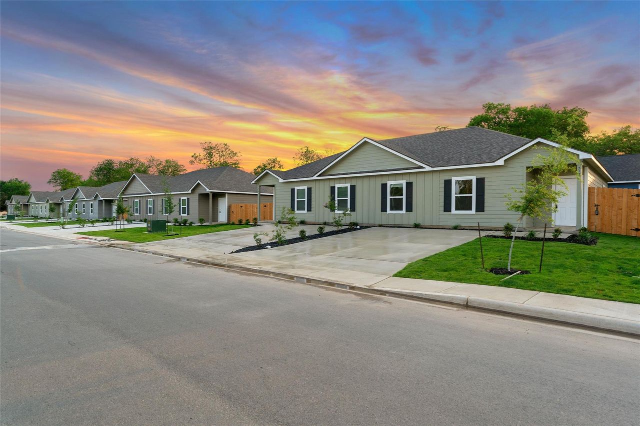 Ranch-style house featuring roof with shingles, board and batten siding, and driveway Ranch-style house featuring roof with shingles, board and batten siding, and driveway