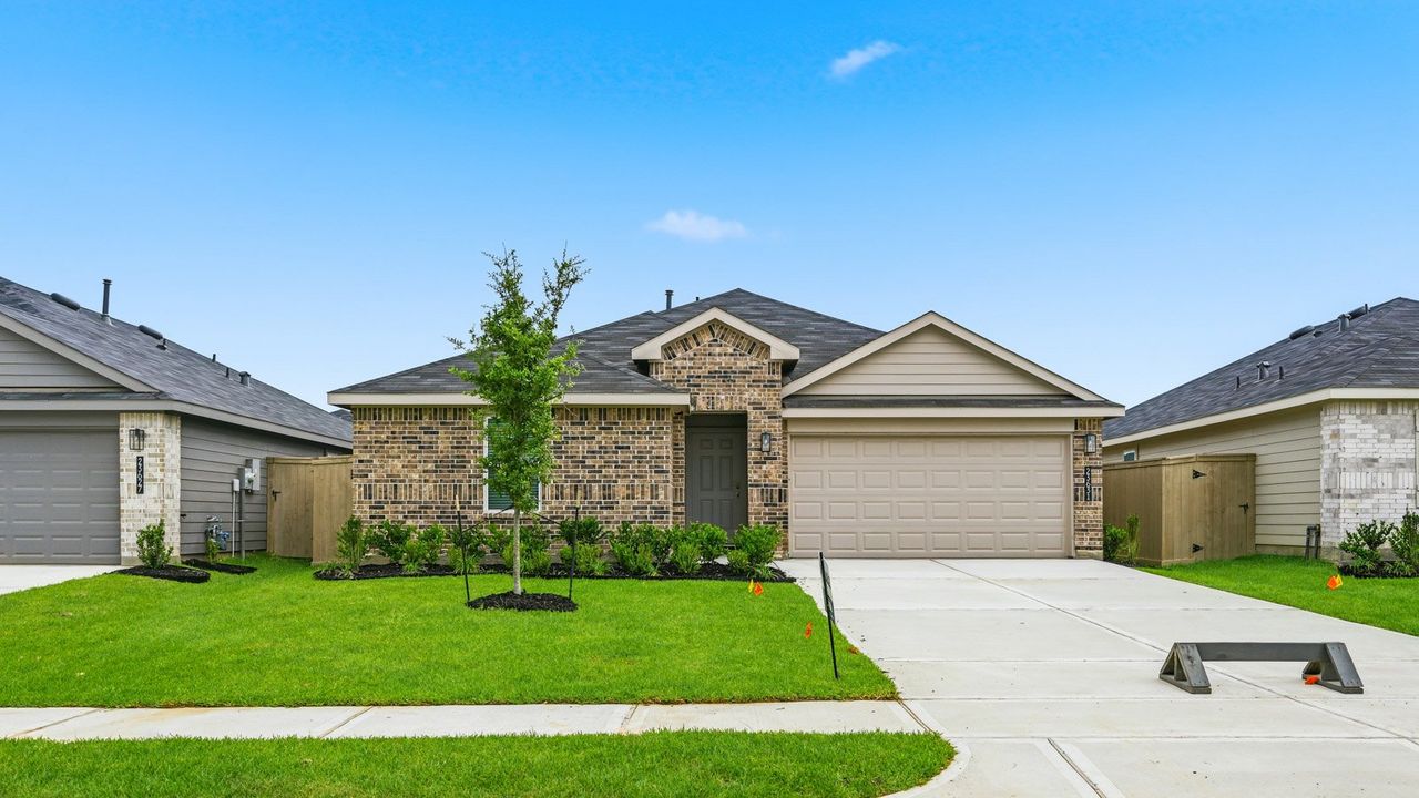 Front exterior of a new home in The Canopies, Splendora, TX, highlighting curb appeal (Image 2).