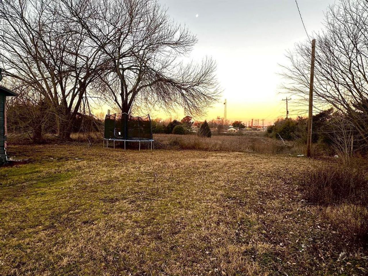 View of grassy yard featuring a trampoline View of grassy yard featuring a trampoline