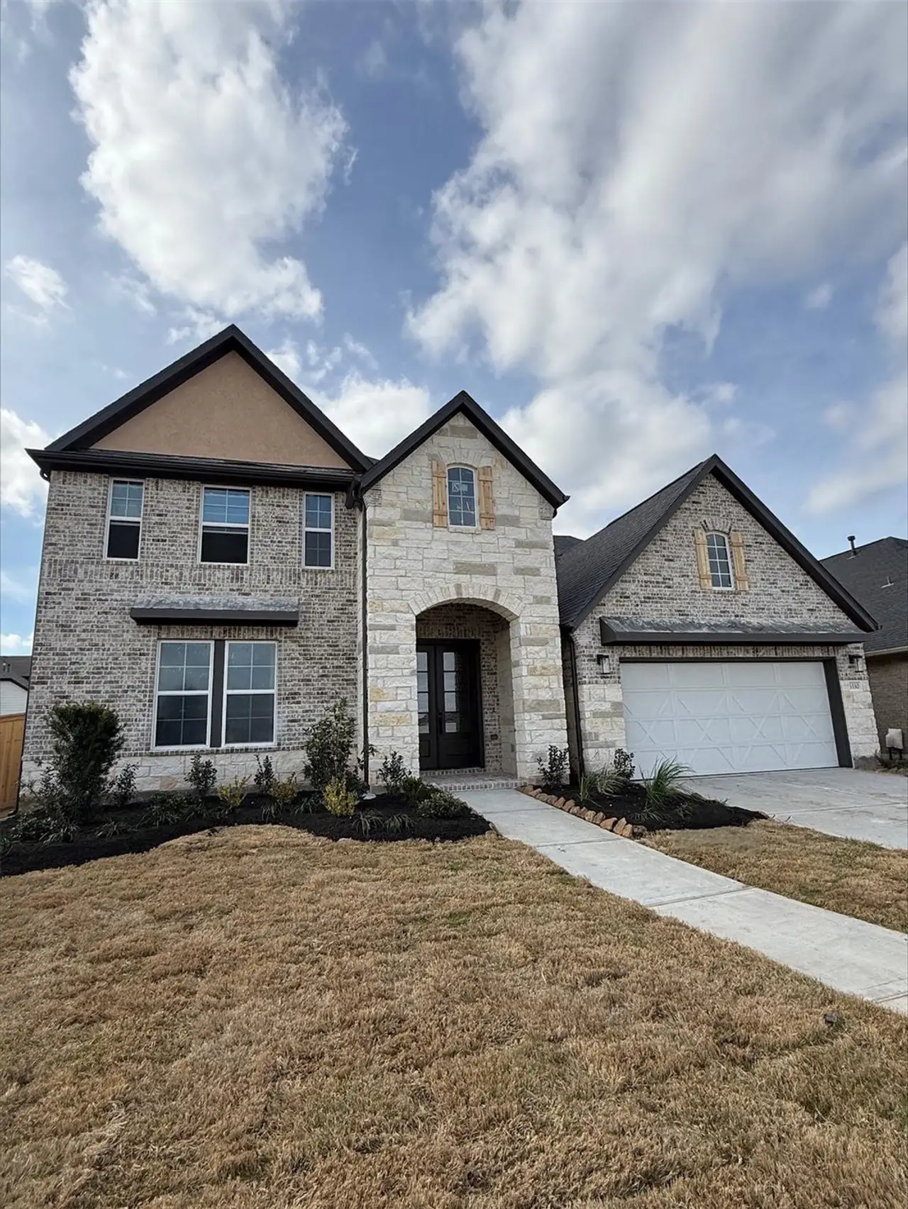 Front exterior of a new home in Valencia, Manvel, TX, highlighting curb appeal (Image 2).