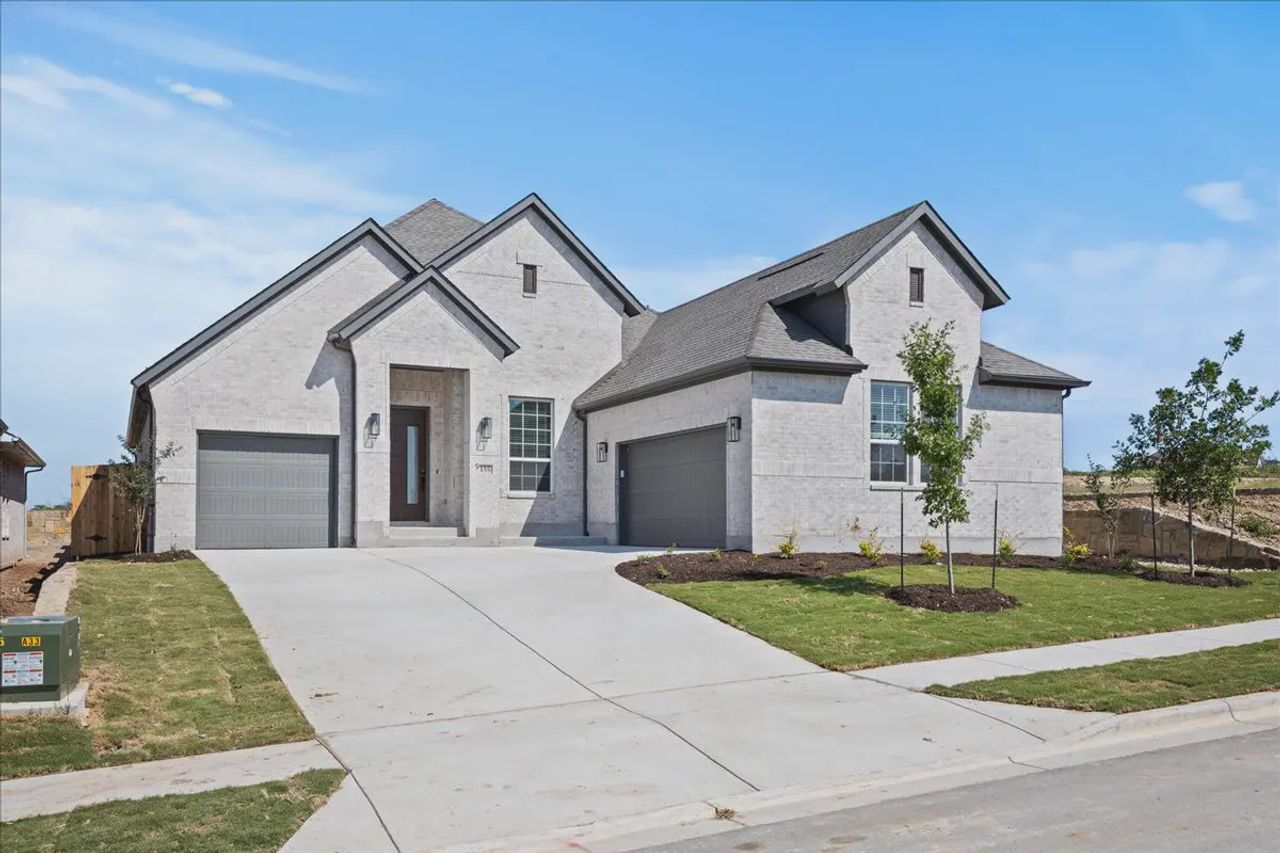 Front exterior of a new home in 6 Creeks, Kyle, TX, highlighting curb appeal (Image 2).