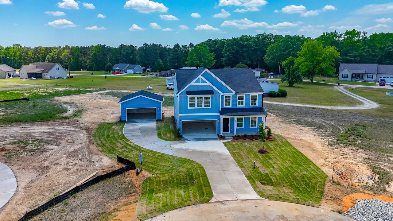 Front exterior of a new home in Cambridge Reserve, Angier, NC, highlighting curb appeal (Image 2).