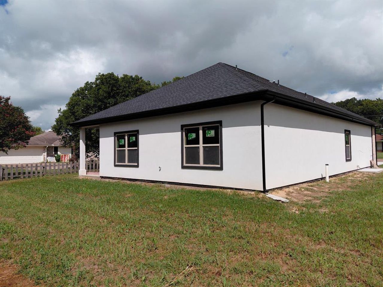 View of home's exterior featuring roof with shingles and stucco siding