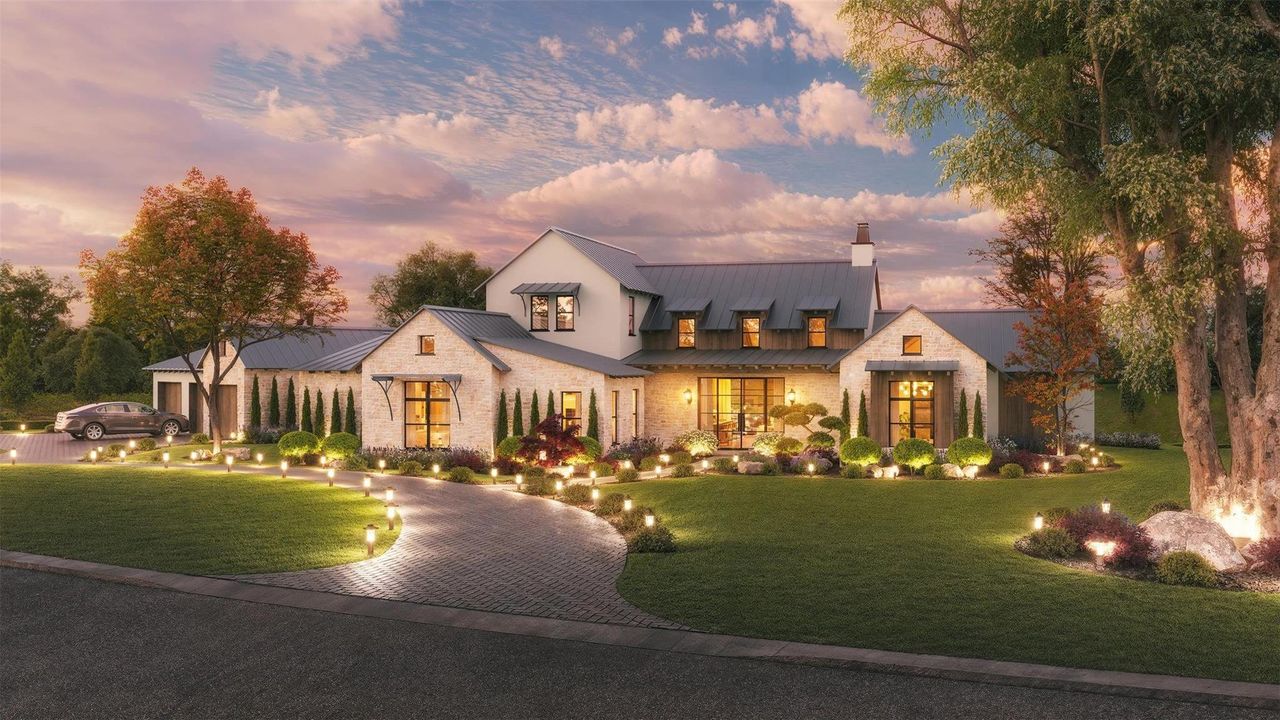 Modern farmhouse with a front lawn, a metal roof, decorative driveway, and a standing seam roof Modern farmhouse with a front lawn, a metal roof, decorative driveway, and a standing seam roof