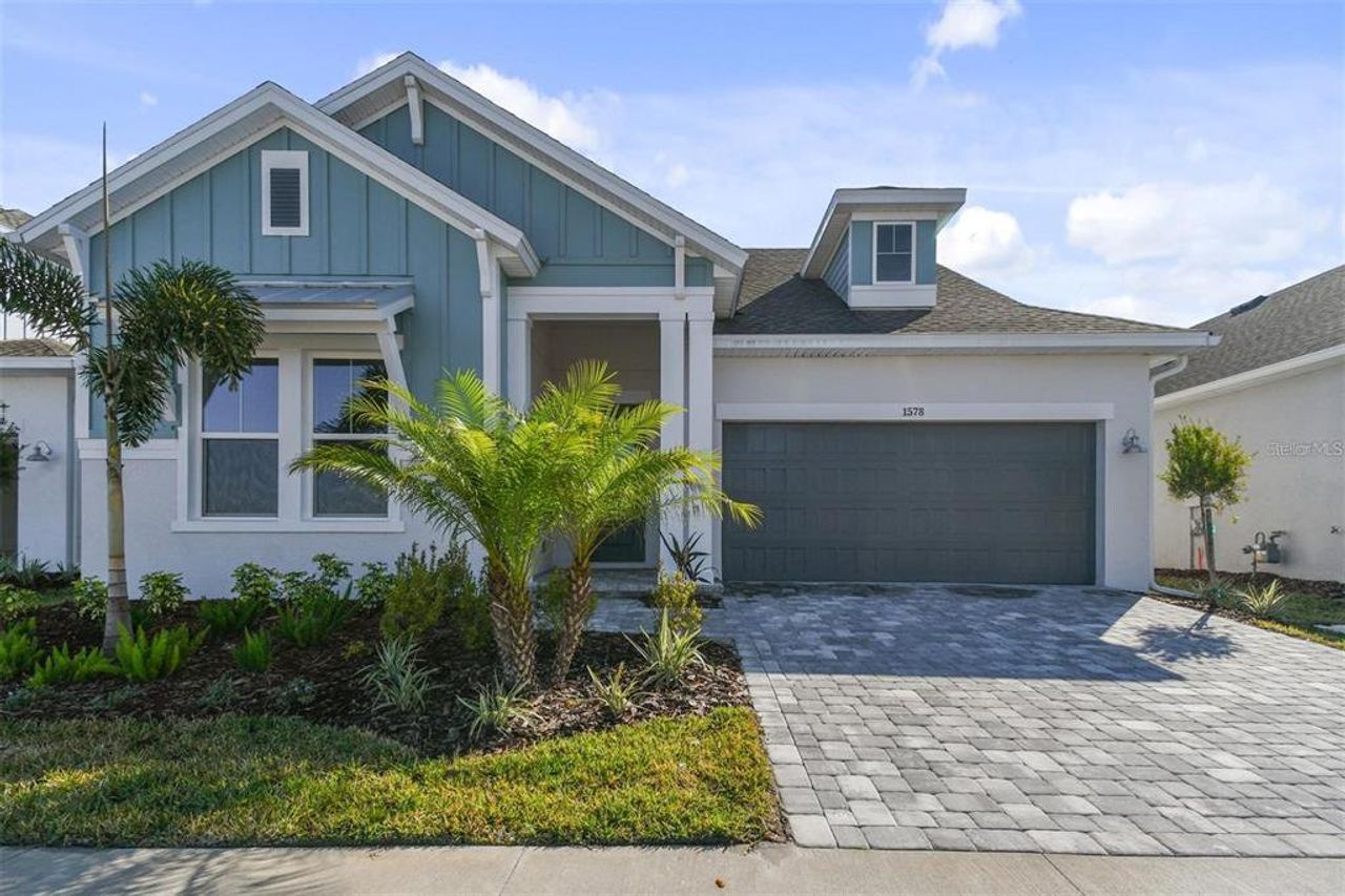 Front exterior of a new home in Emerald Landing at Waterside at Lakewood Ranch – Lake Series, Sarasota, FL, highlighting curb appeal (Image 2). Front exterior of a new home in Emerald Landing at Waterside at Lakewood Ranch – Lake Series, Sarasota, FL, highlighting curb appeal (Image 2).
