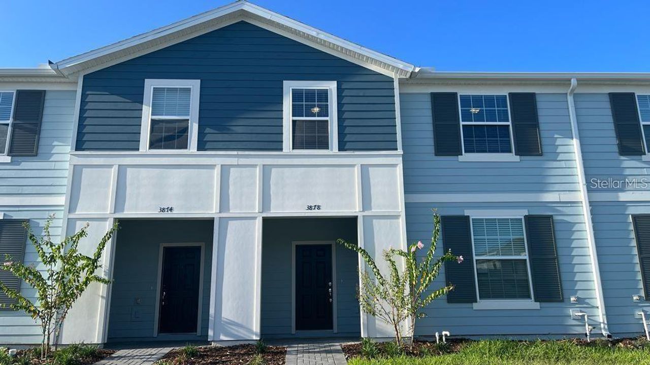 Front exterior of a new home in Windsor Island Resort, Davenport, FL, highlighting curb appeal (Image 2).