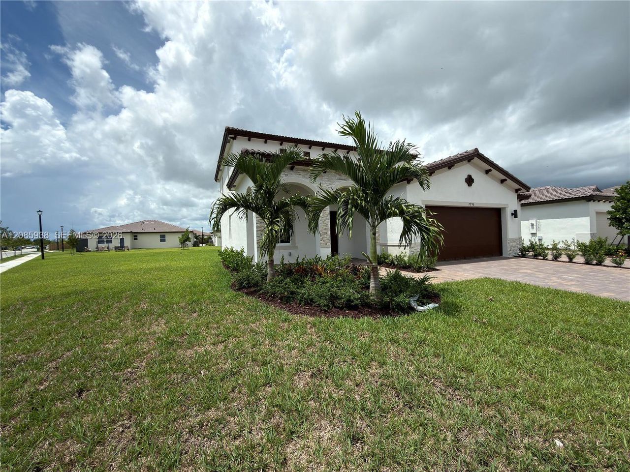 Front exterior of a new home in , Homestead, FL, highlighting curb appeal (Image 2). Front exterior of a new home in , Homestead, FL, highlighting curb appeal (Image 2).
