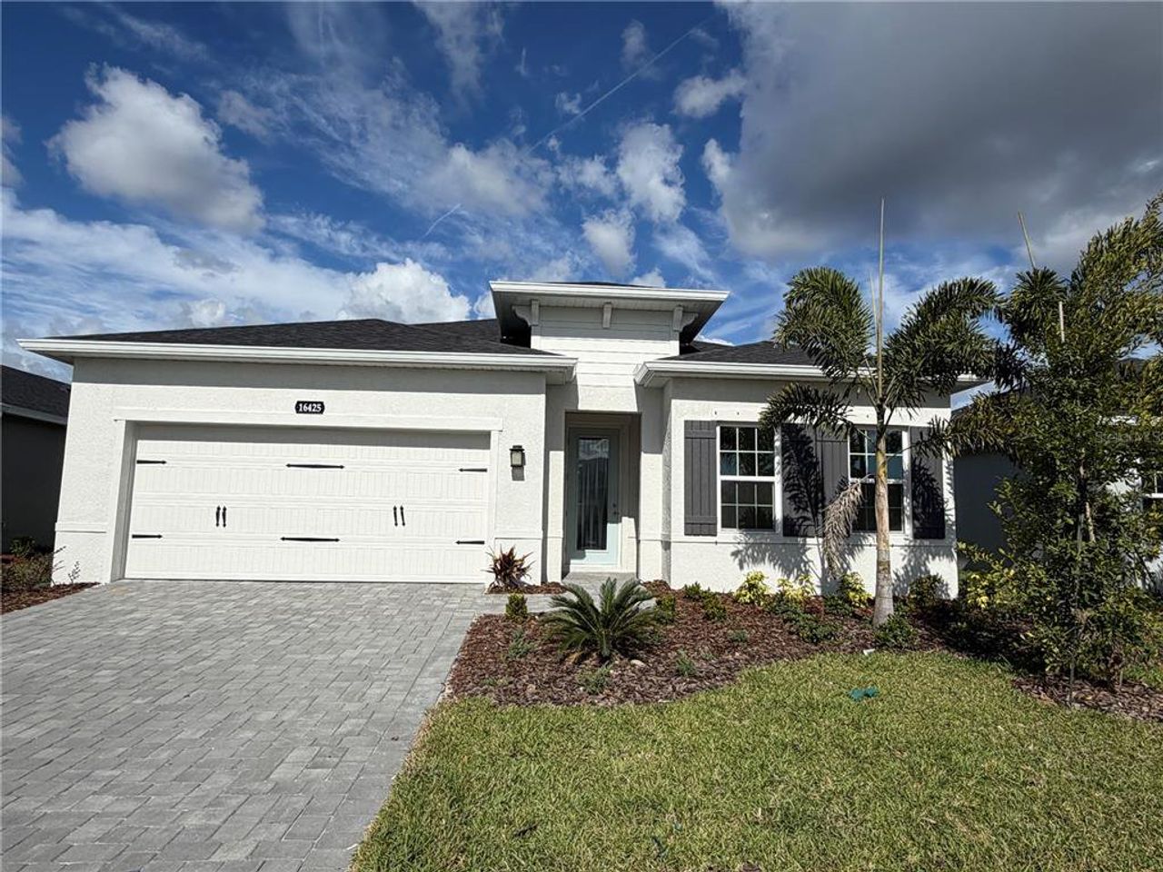 Front exterior of a new home in West Port Single Family Homes, Port Charlotte, FL, highlighting curb appeal (Image 2).