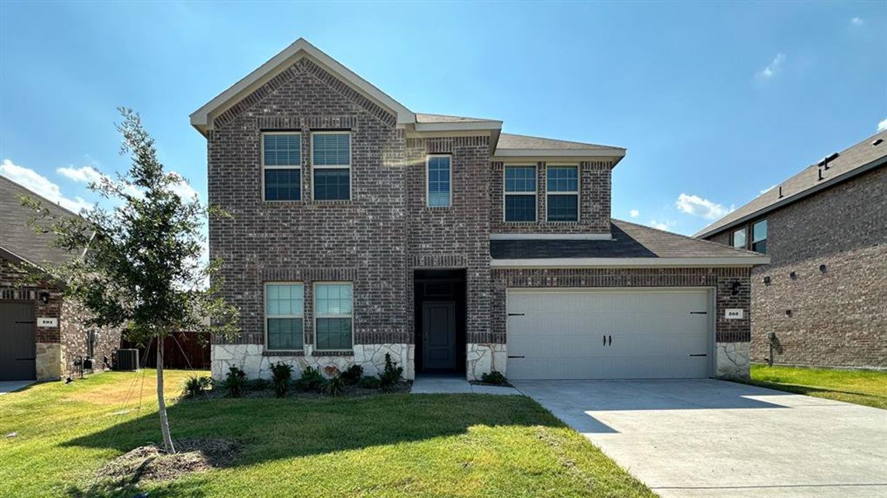 Front exterior of a new home in Stonehaven, Caddo Mills, TX, highlighting curb appeal (Image 2). Front exterior of a new home in Stonehaven, Caddo Mills, TX, highlighting curb appeal (Image 2).