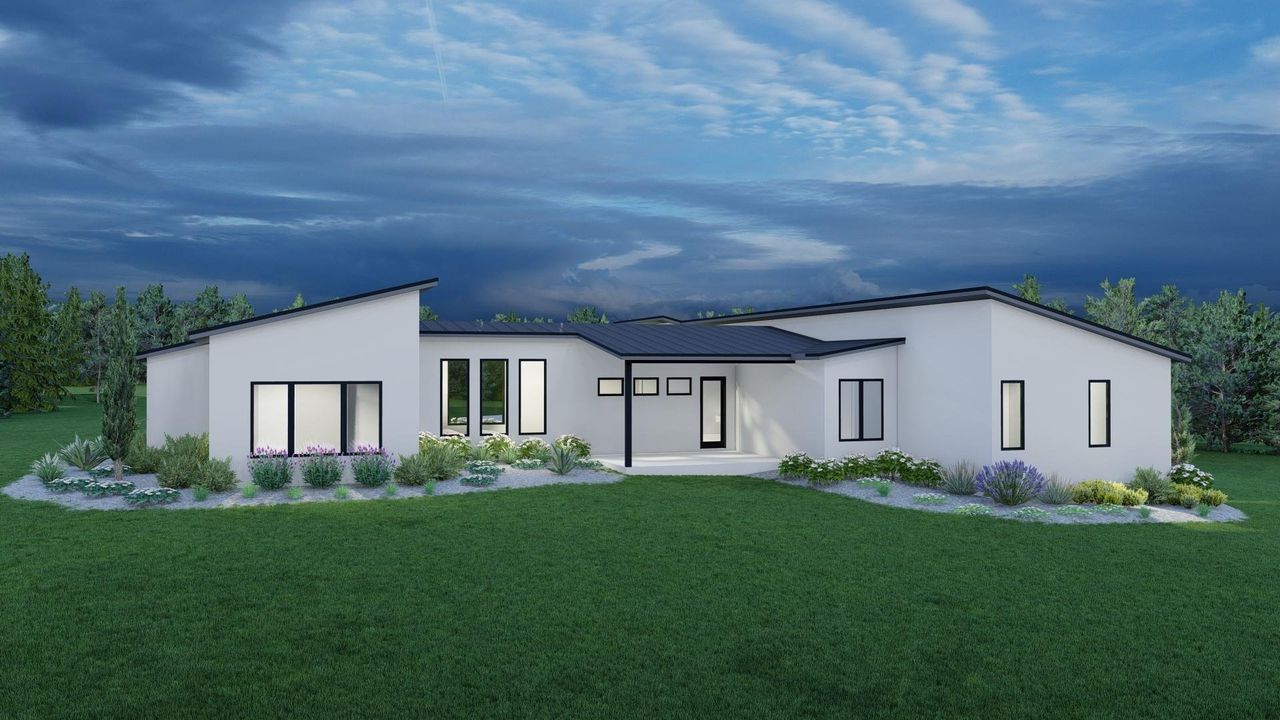 Rear view of house with a lawn and stucco siding