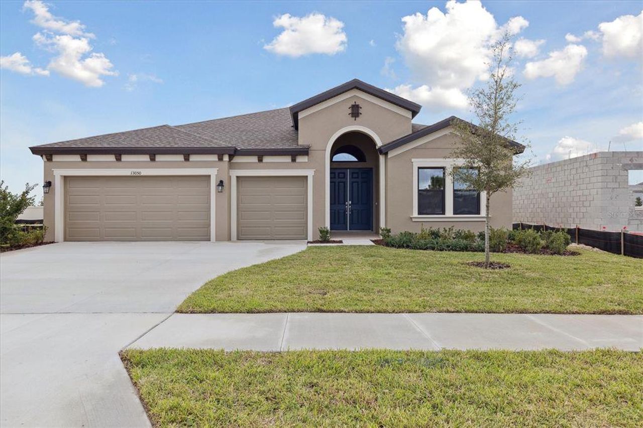 Front exterior of a new home in Caldera, Spring Hill, FL, highlighting curb appeal (Image 2).