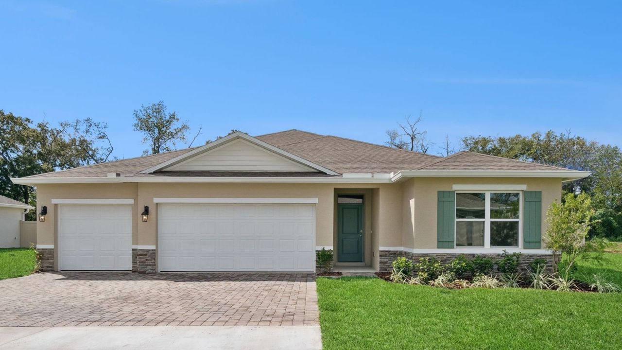 Front exterior of a new home in Ironwood, Daytona Beach, FL, highlighting curb appeal (Image 2).