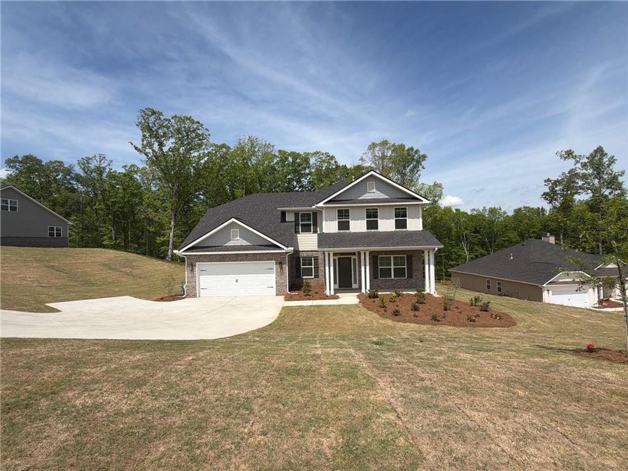 Front exterior of a new home in Tuscany Hills, Douglasville, GA, highlighting curb appeal (Image 2).
