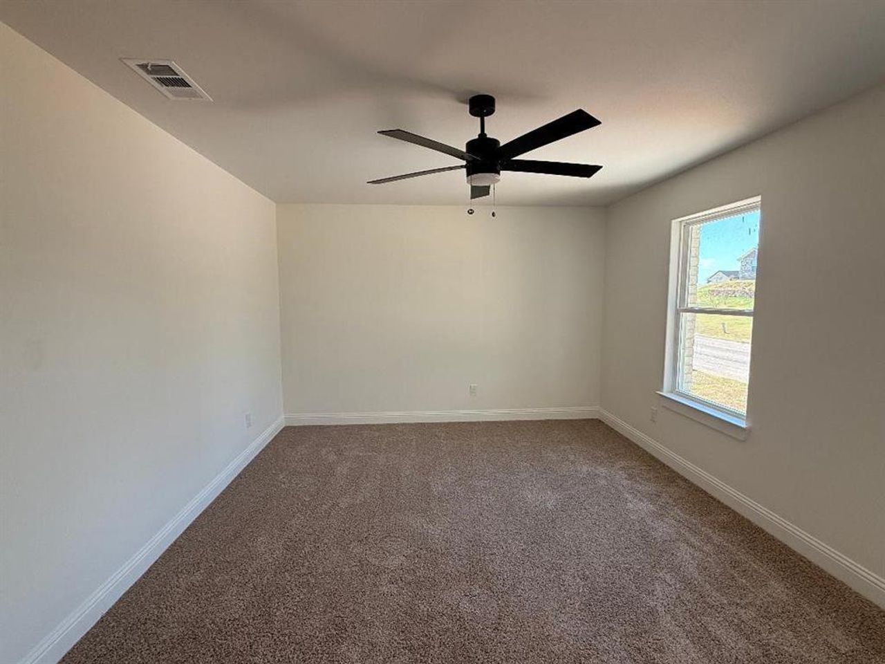 Spare room featuring carpet floors and ceiling fan Spare room featuring carpet floors and ceiling fan
