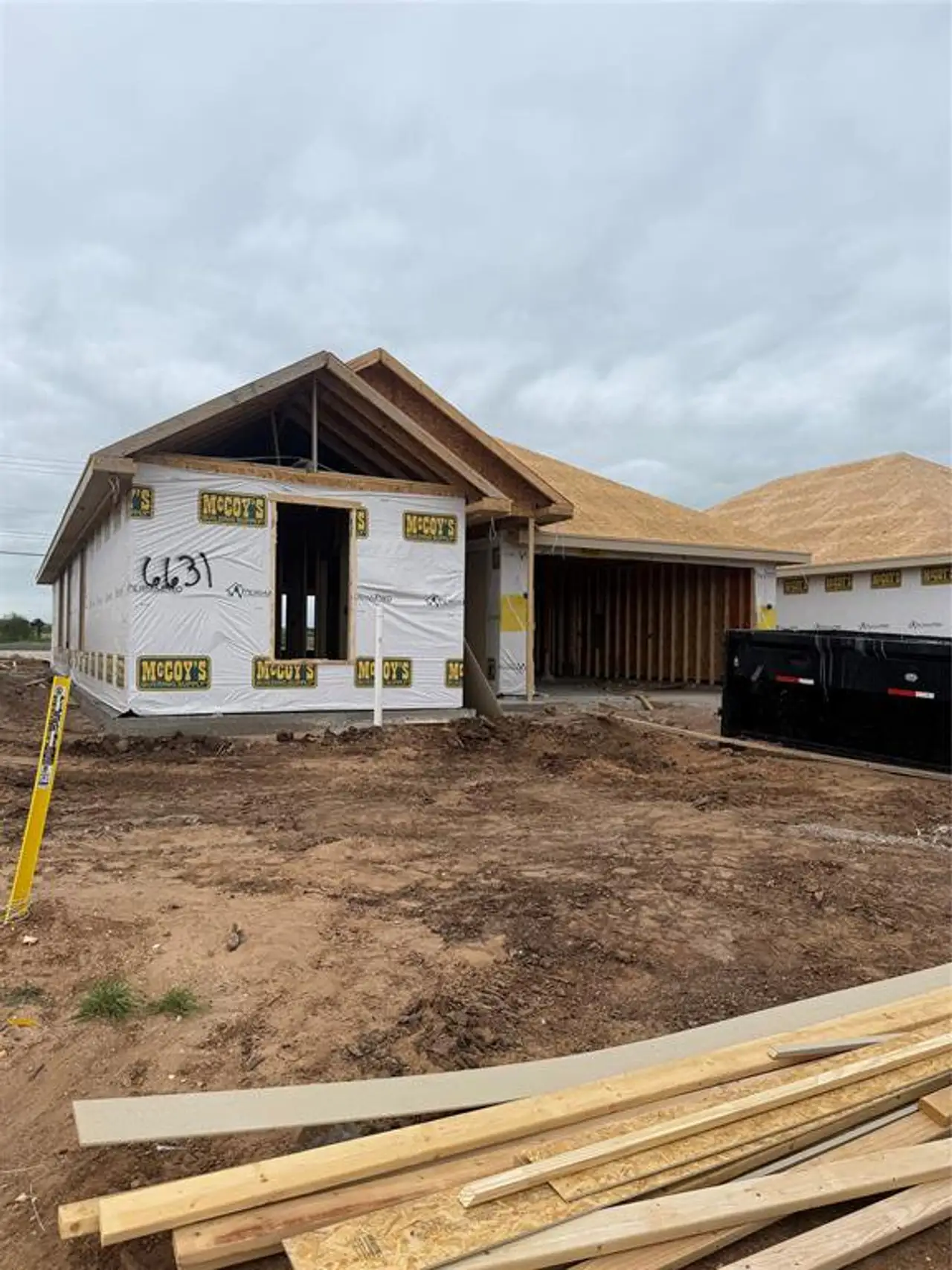New construction residence featuring a framed structure, complete roof sheathing, and foundational slab