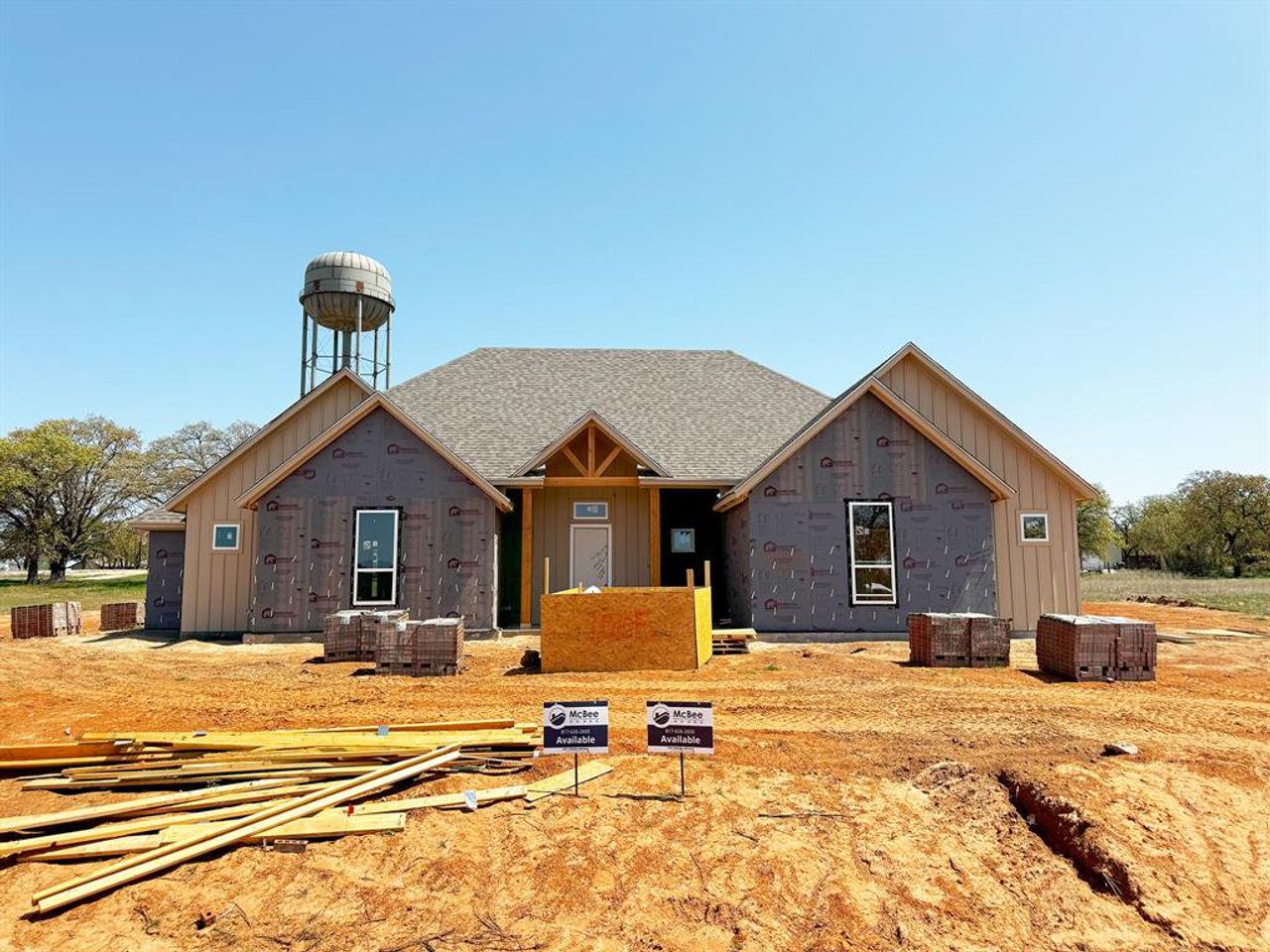 Property under construction featuring a shingled roof and board and batten siding Property under construction featuring a shingled roof and board and batten siding