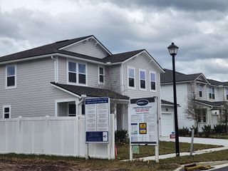 Street view Charming gray two-story home with white trim in Olde Mandarin Estates by Mattamy Homes (Jacksonville, FL).
