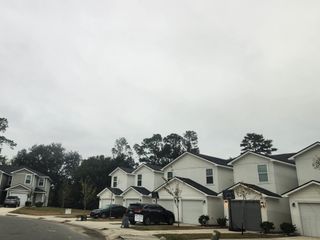 Street view Modern townhomes with garages in Lakeside Townhomes by Lennar, nestled in a serene neighborhood in Jacksonville, FL.