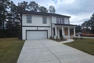 Street view A modern white siding home with a two-car garage in Creekside by MacBuilt Homes (Decatur, GA).