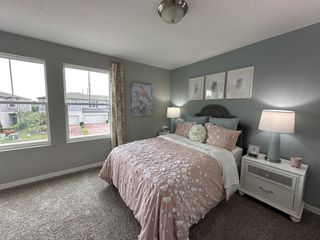 A cozy bedroom featuring soft floral bedding, pastel walls, and elegant lamps, creating a tranquil, inviting ambiance.