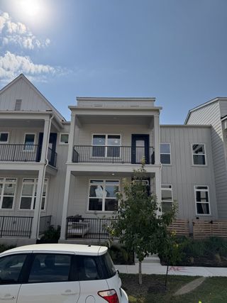 Street view A modern two-story home with balconies and a landscaped front in Mueller 11 - 22.5 X 90 Row Home by Lennar (Austin, TX).