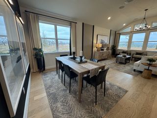 A cozy living room with rustic décor, vaulted ceilings, and scenic views in Veramendi by Brightland Homes (New Braunfels, TX).