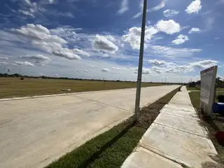 Street view Open landscape under a blue sky in Sweetgrass Village: Landmark Collection by Beazer Homes (Crosby, TX).