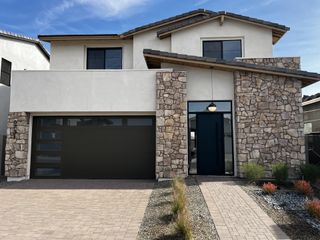 Street view A modern two-story home with stone accents in Ocotillo Lane by Porchlight Homes (Phoenix, AZ).
