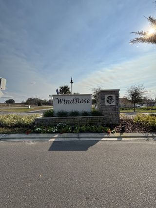 A beautifully landscaped entrance sign welcomes you to the Windrose community by D.R. Horton (Apopka, FL).