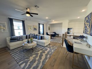 A spacious open-concept dining and living area with high ceilings, elegant decor, and natural light.