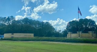 A welcoming entrance with lush greenery in Reflections at Nocatee by Providence Homes (Nocatee, FL).