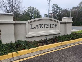 Street view Elegant entrance sign surrounded by greenery in Lakeside Townhomes by Lennar (Jacksonville, FL).