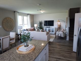 Bright and modern living area featuring a neutral palette, large windows, and stylish furnishings for a welcoming atmosphere.