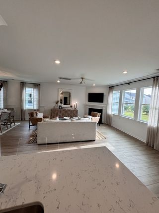 A spacious living area with modern decor, a cozy sofa, and large windows offering abundant natural light.